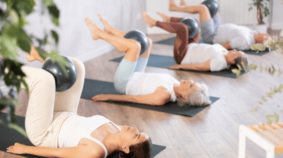 a woman is doing a yoga pose on a yoga mat