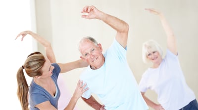 a man and woman doing a yoga class