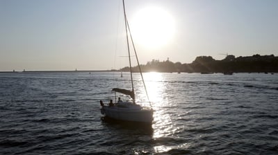 The sailboat Monark sailing on the Douro River at sunset