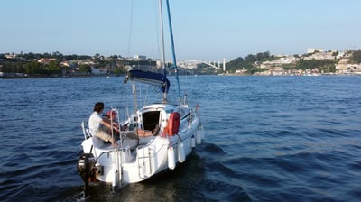 Our sailboat Monark cruising on the Douro River on a sunny day