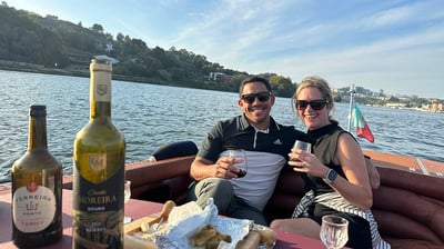 A couple enjoying wine and snacks on the James Bond–style speedboat Eskrok