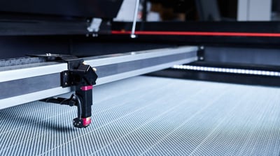 a machine is cutting a piece of metal with a laser laser machine