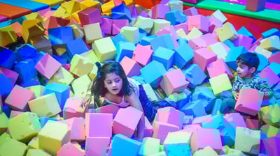 a child's play area with a large pile of colorful blocks
