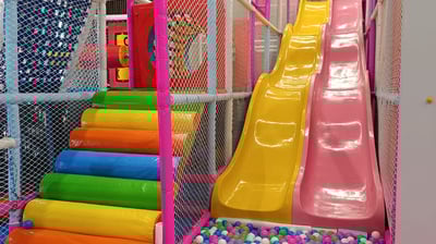 a colorful ball pit with a slider and a slider
