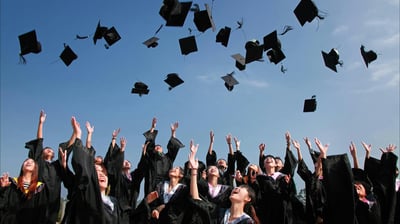 Graduation class throwing on the air