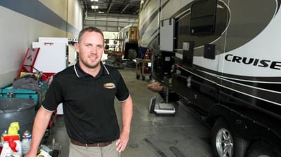 Class A motorhome mechanic performing in shop repair