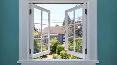 a window with a view of a house and garden