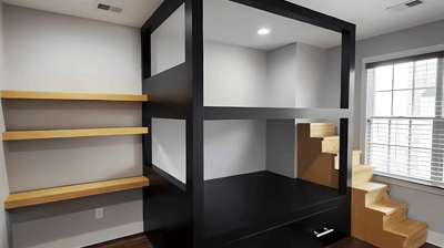 a room with a desk and shelves with shelves