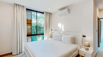 a bedroom with a bed and a window