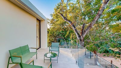 a balcony with a bench and chairs and a bench