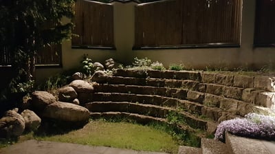 terrassenförmig angelegte Sandsteinbloecke mit Findlingen ergaenzt