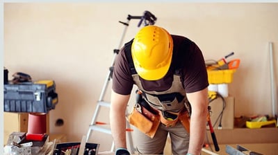 Tra workers renovating interior walls and ceilings in a commercial building