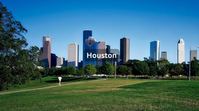 Downtown Houston Texas on a bright sunny day with green grass