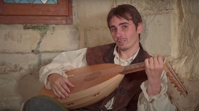 a man in a vest playing a musical instrument