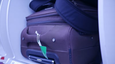 a suitcase with luggage on it and a suitcase on the ground