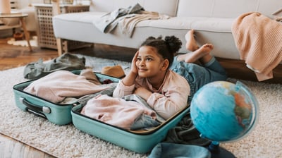 a young girl sitting on a rug in a living room