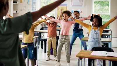 Students doing physical movement in the classroom.