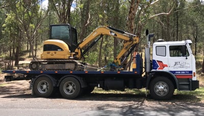 transporting an excavator to its new work location