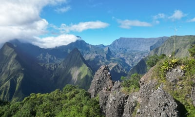a person on a mountain top with a view of mountains