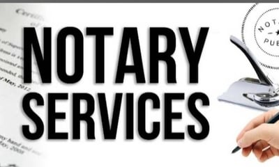 a person holding a pen and writing a note pad advertising notary services