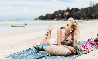 A fashionable woman posing on a beach during a lifestyle photoshoot for a jewelry brand on Koh Samui