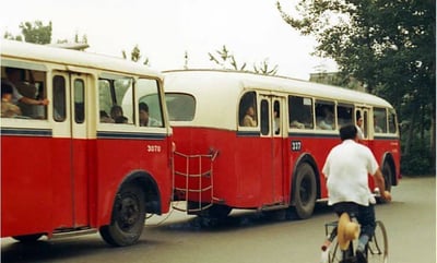 a man riding a bicycle with a bicycle in front of a bus