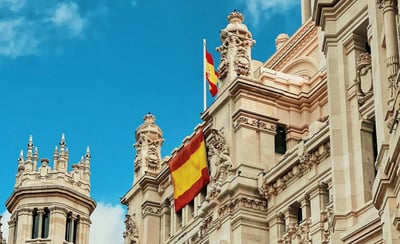 a large building with a spanish flag on top of it