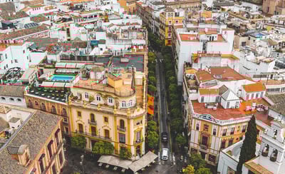 a cityscape of a city with a fountain in the foreground