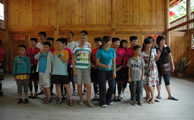 Tracey Billington with thetraditional long haired women at Huangluo Yao Village, China