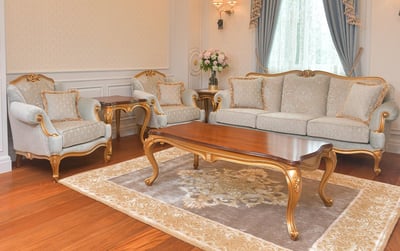 a living room with a calssic modern handmade sofa set, armchair, side table and coffee table