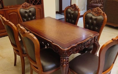 a dining room table with a wooden table and chairs