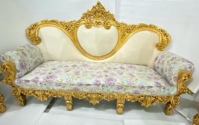 a couch with a gold leafed pattern on it