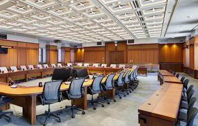 a conference room with a large wooden table and chairs