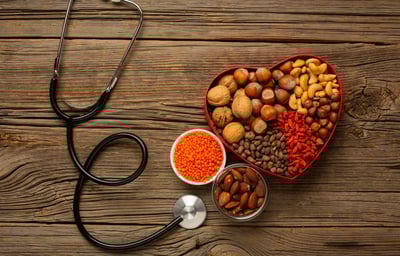 a heart shaped bowl with nuts