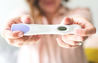 woman holding pregnancy test