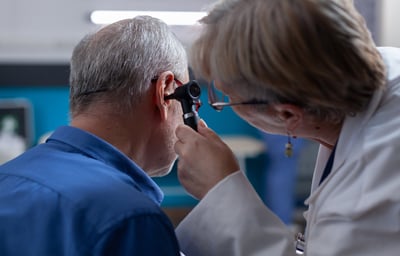 a doctor examining a patient's ear and ear