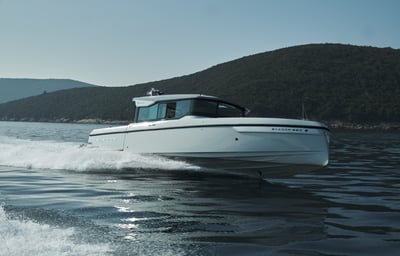 Speedboat floating on the water in full speed.