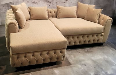 Beige tufted sectional with plush cushions and rolled arms, custom-designed by Solo Home Decor.