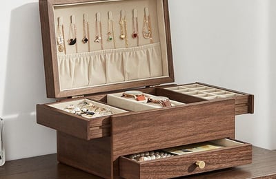 a jewelry box with jewelry and jewelry on a dresser