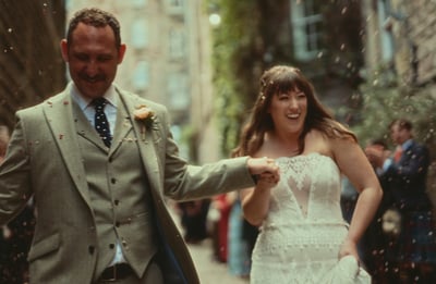 a man and woman walking down a street