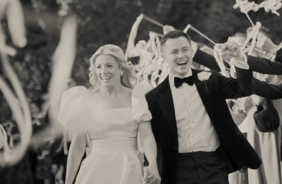 a bride and groom walking down a path with confettirs