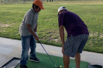 Enhancing Forward Action Inc. image young golfer being taught golf