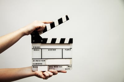 someone holding a movie style clapper board