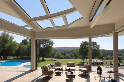 Three woven lampshades hang from a pergola structure made of white beams, with a bright blue sky in the background. Lush green plants rise up to fill the view, creating a natural contrast against the geometric lines above.