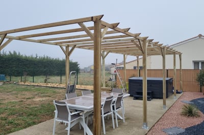 a patio with a table and chairs and a hot tub
