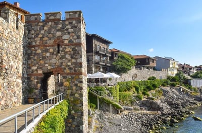 a stone wall with a bridge and a bridge over it