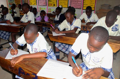 a group of children sitting at desks in a classroom