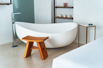 a bathtub with a wooden stool and a stool with a stool