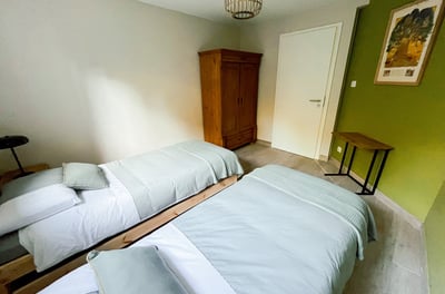 a bedroom with two beds and a table