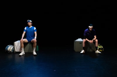 The Last Match - Two actors (one stiff, one hunched) sitting on blocks, separated by darkness